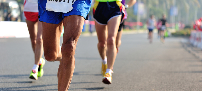 Marathon running race, people feet on city road