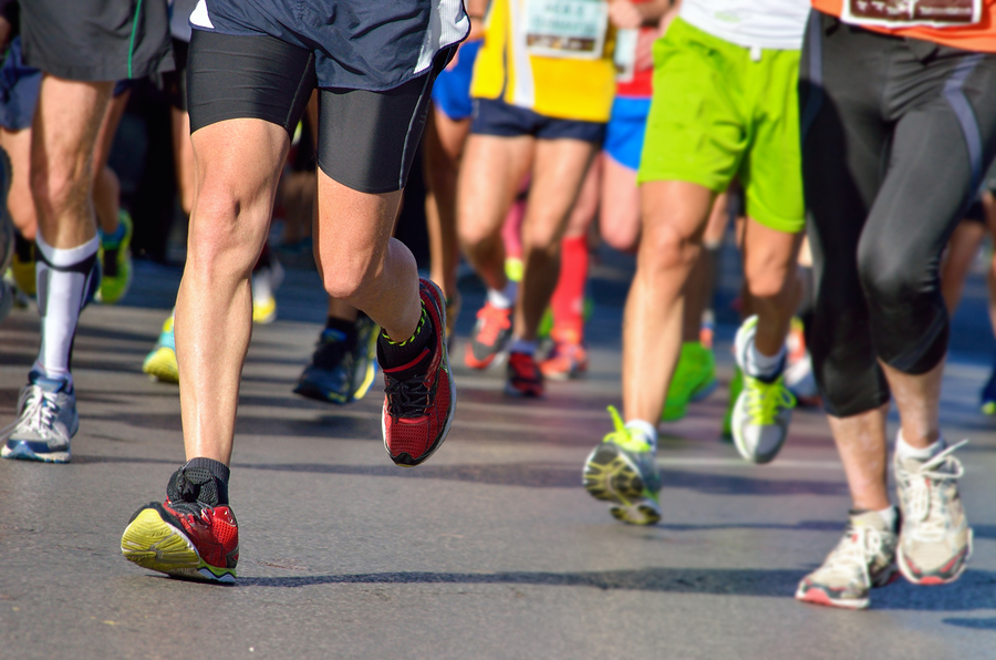 Marathon running race, runners feet on road