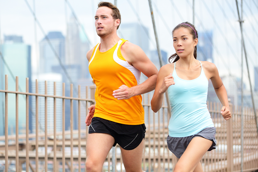 Running couple jogging training for New York marathon. Runners o