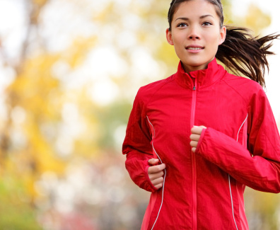 Woman runner running in autumn